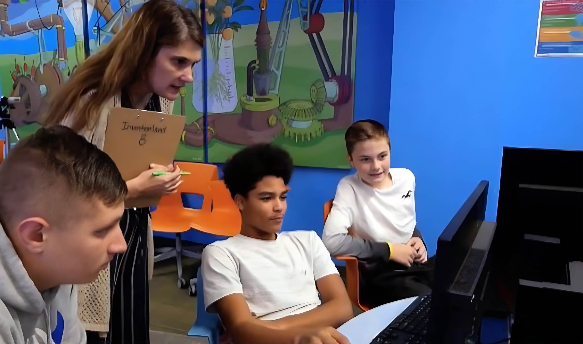 students and teacher working on an assignment